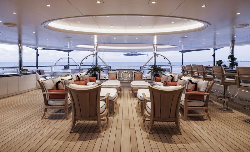 a room with tables and chairs aboard AHPO Yacht for Charter