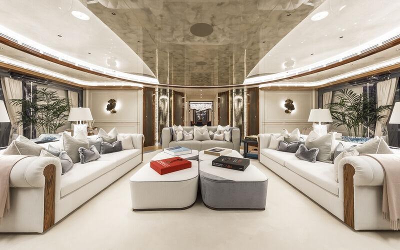 a room with white furniture aboard AHPO Yacht for Charter