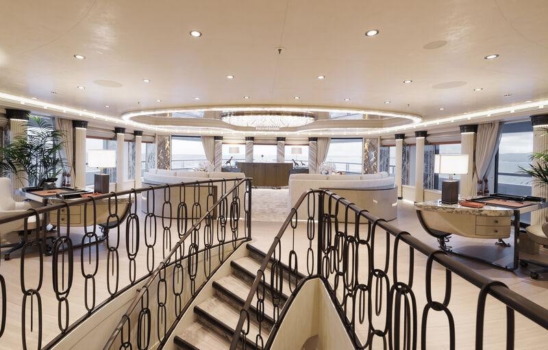 a large room with tables and chairs aboard AHPO Yacht for Charter