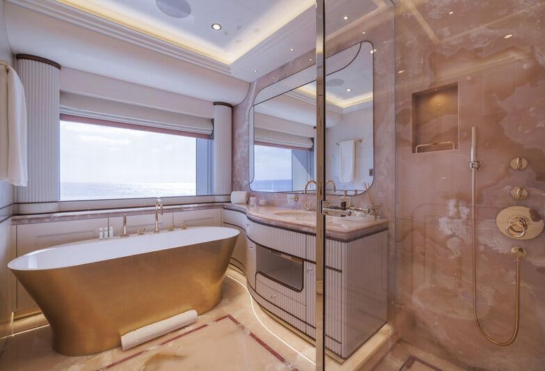 a bathroom with a tub and shower aboard AHPO Yacht for Charter