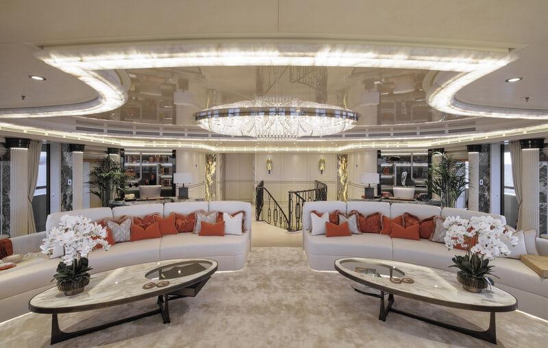 a large white room with a couch and a table aboard AHPO Yacht for Charter