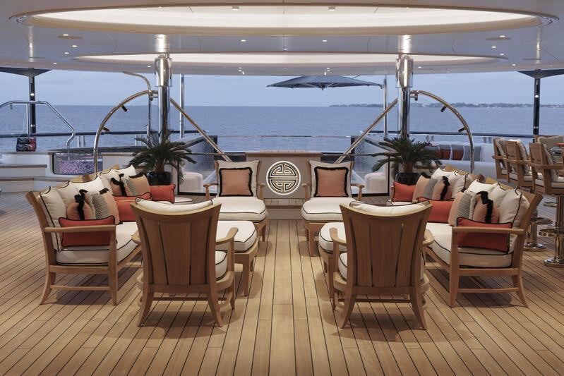 a room with a table chairs and plants on the wall aboard AHPO Yacht for Charter