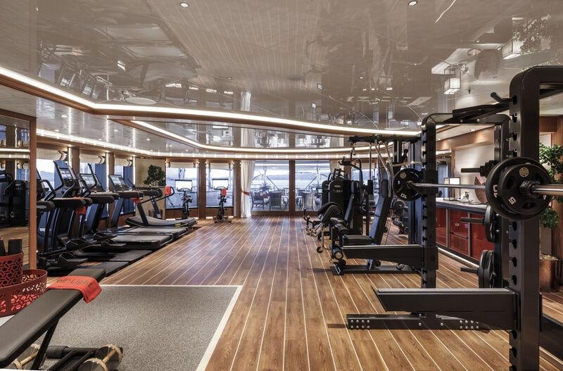 inside of a building with a large gym aboard AHPO Yacht for Charter