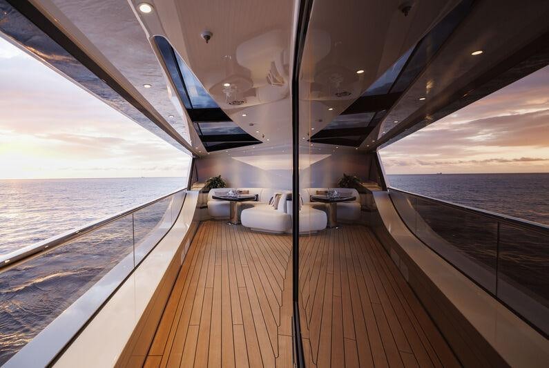 a deck with a view of the ocean and the ocean aboard AHPO Yacht for Charter