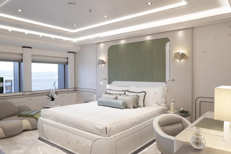 a room with a bed and a chair aboard AHPO Yacht for Charter