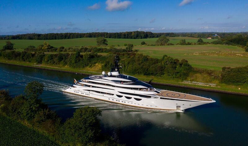 a white yacht on a river aboard AHPO Yacht for Charter