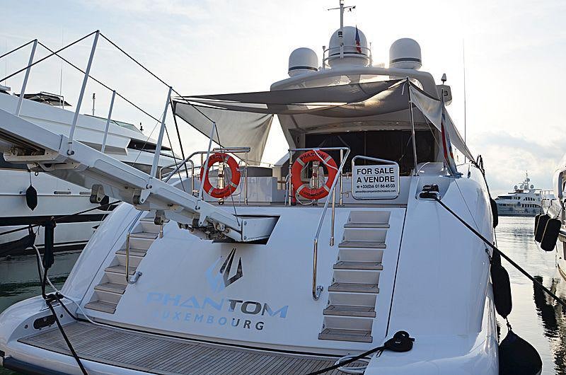 a large white boat with a red light on the front aboard LADY B Yacht for Charter
