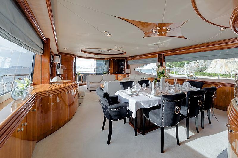a dining room with a large window aboard BABY I Yacht for Charter