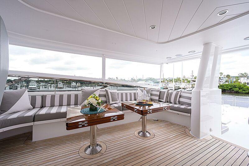 a living room with a large white column and a table with a white pillar and a white pillar aboard UNWINED Yacht for Charter