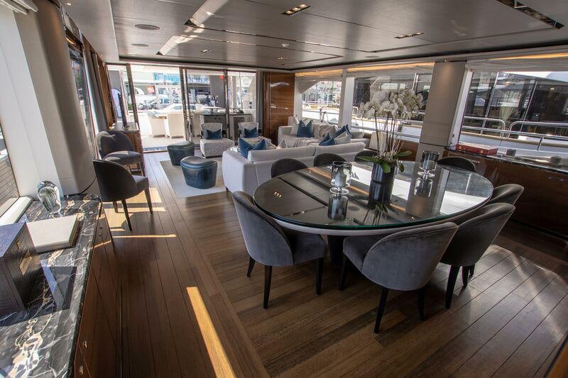 a table with chairs around it aboard KOHUBA Yacht for Charter