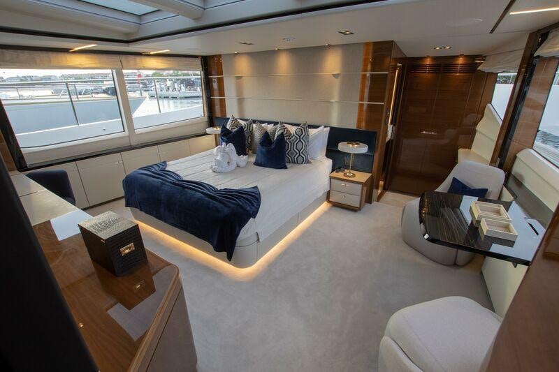 a room with a bed and a table aboard KOHUBA Yacht for Charter
