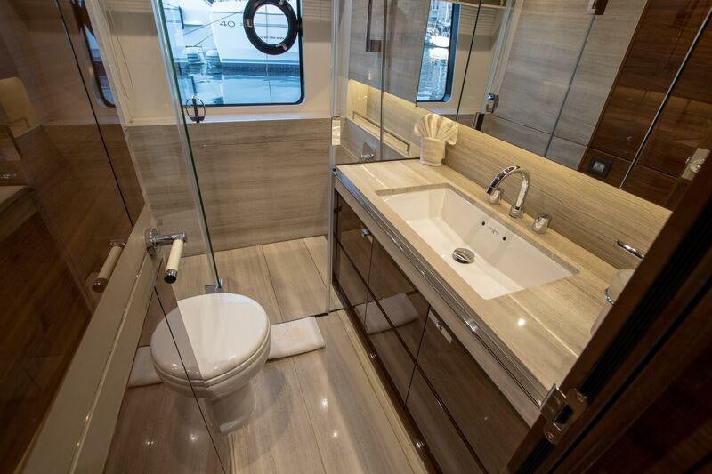 a bathroom with a large mirror aboard KOHUBA Yacht for Charter