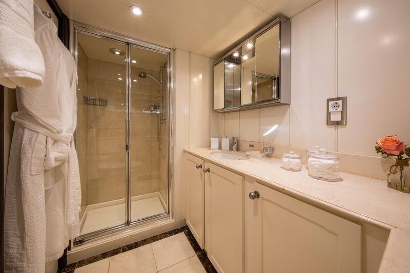 a bathroom with a glass shower aboard ODYSSEY III Yacht for Charter