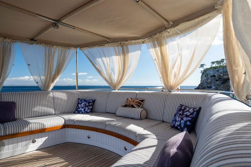 a bed with a canopy aboard ODYSSEY III Yacht for Charter