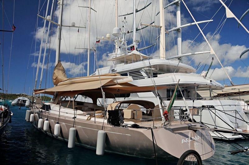 a large white boat with a large sail aboard ACAIA Yacht for Charter