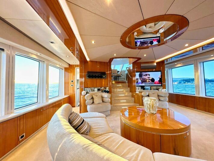 a living room with a large window aboard SEA BREEZE ONE Yacht for Charter