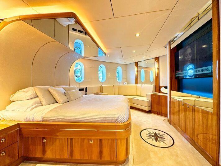 a room with a bed and a large window aboard SEA BREEZE ONE Yacht for Charter