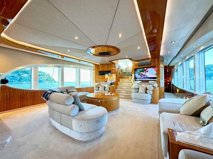 a living room with a large window aboard SEA BREEZE ONE Yacht for Charter