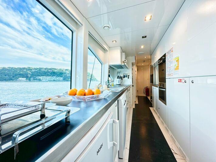 a kitchen with a large window aboard SEA BREEZE ONE Yacht for Charter