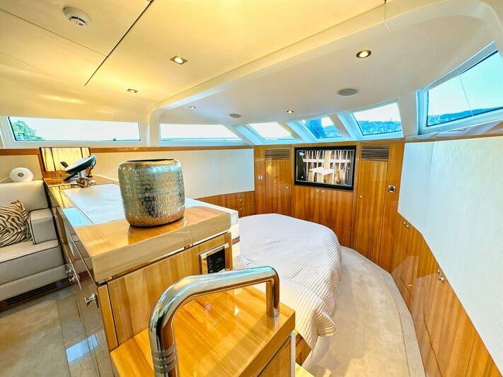 a room with a bed and a table aboard SEA BREEZE ONE Yacht for Charter