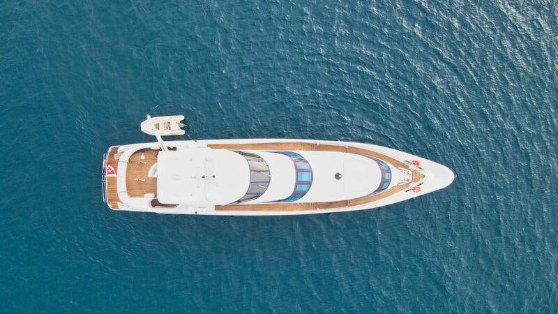a white and silver boat on a blue surface aboard SEA BREEZE ONE Yacht for Charter