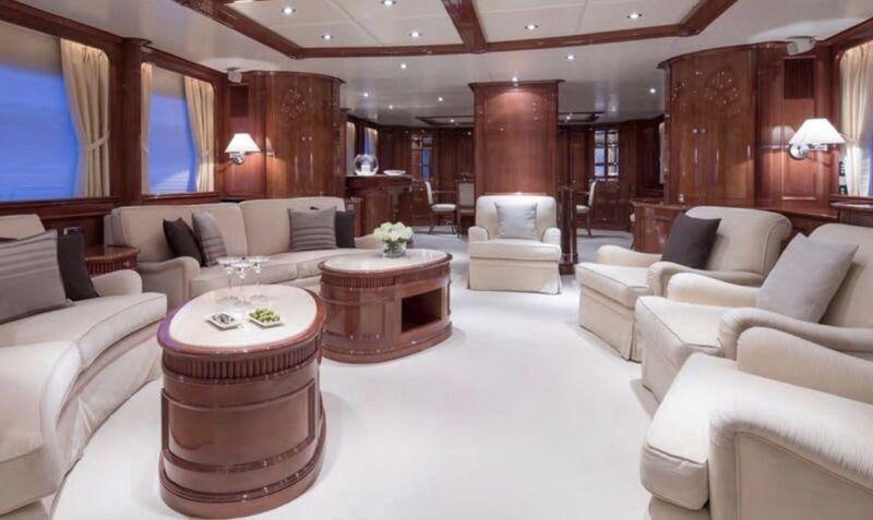 a living room with a table and chairs aboard FRIENDSHIP Yacht for Charter
