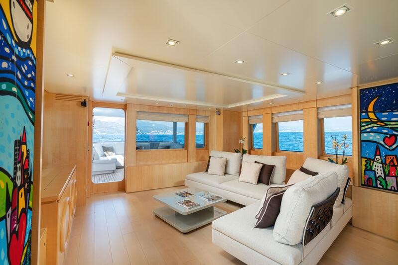 a living room with a large window aboard ATOM Yacht for Charter