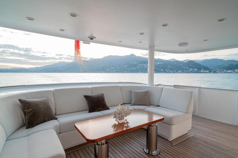 a white couch with pillows on it aboard ATOM Yacht for Charter