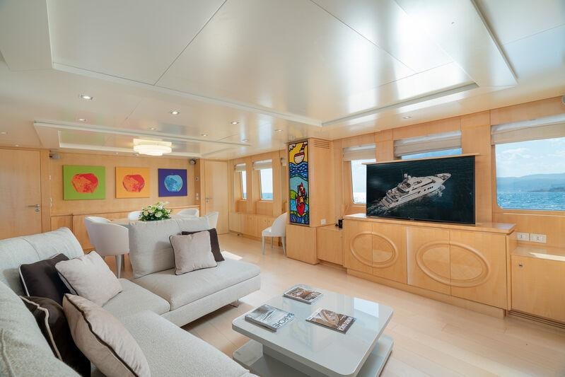 a living room with a large screen aboard ATOM Yacht for Charter