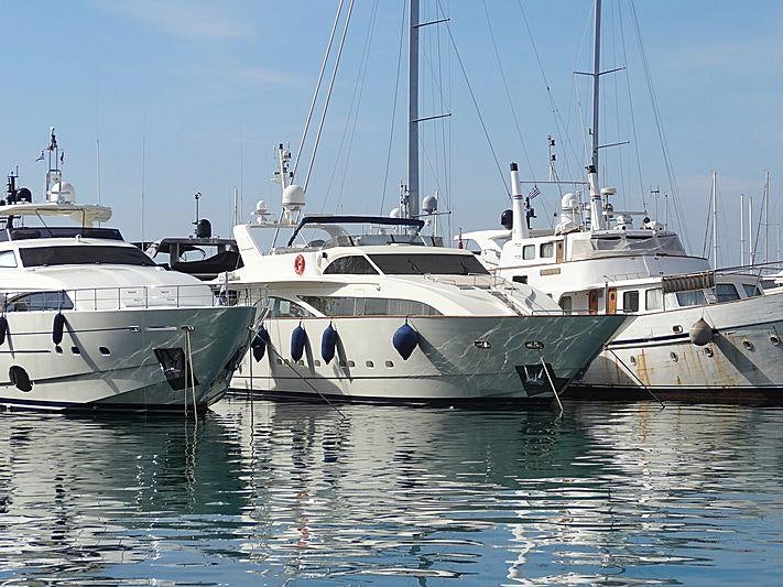 several white yachts in a harbor aboard DREAM B Yacht for Charter