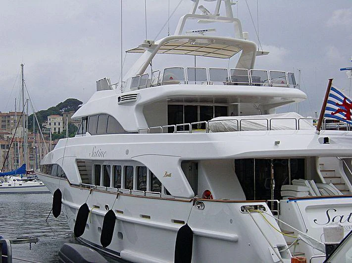 a boat with a flag on the front aboard SATINE Yacht for Charter