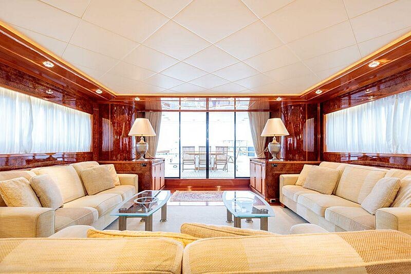 a living room with a large window aboard OVAL Yacht for Charter