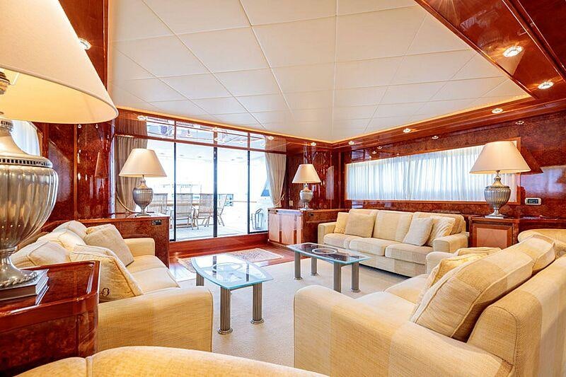 a living room with a large window aboard OVAL Yacht for Charter