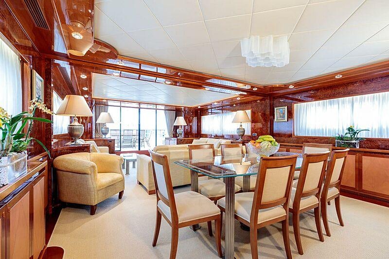 a large dining room with a large table and chairs aboard OVAL Yacht for Charter