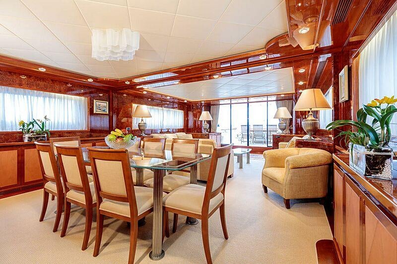 a large dining room with a large table and chairs aboard OVAL Yacht for Charter