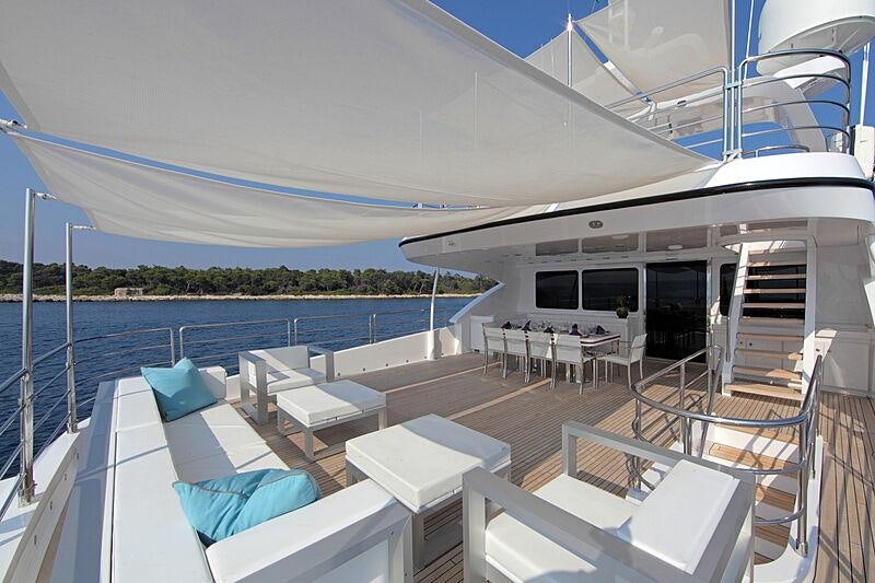 a deck with a large pool and a deck with chairs and a deck aboard SEA SHELL Yacht for Charter