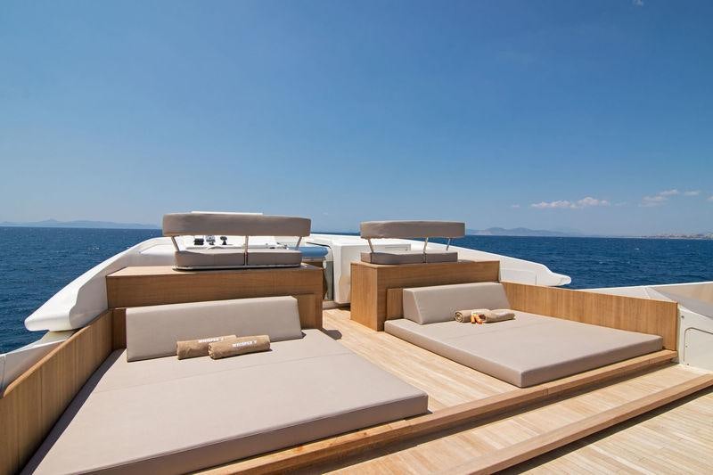 a deck with a view of the ocean and the ocean aboard WHISPER V Yacht for Charter