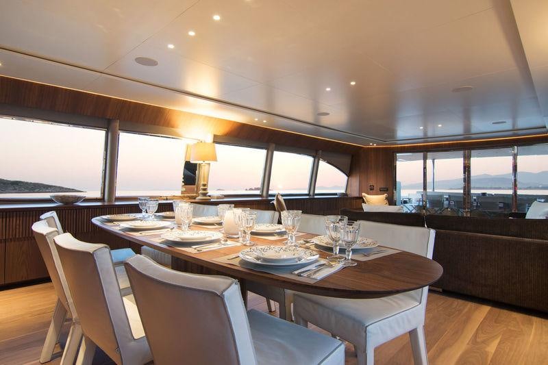 a dining table with glasses and plates aboard WHISPER V Yacht for Charter
