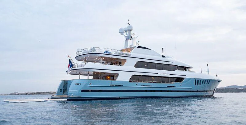 a large white boat on the water aboard MUSTIQUE Yacht for Charter