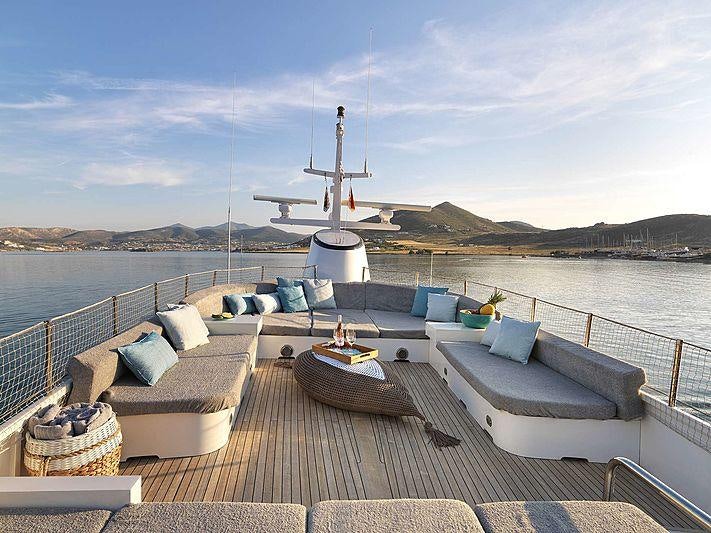 a dock with a boat and a large windmill on it aboard SOUNION II Yacht for Charter