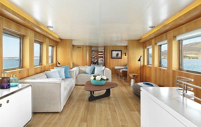 a living room with a couch and a table aboard SOUNION II Yacht for Charter
