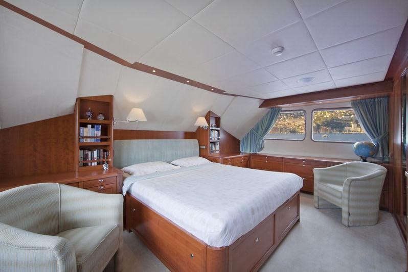 a bedroom with a bed and a couch aboard CORNELIA Yacht for Charter