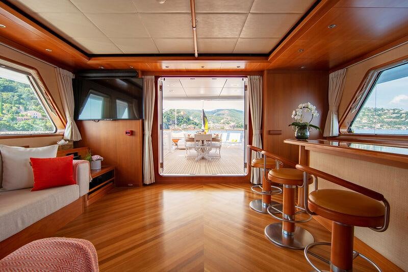 a living room with a large window aboard CORNELIA Yacht for Charter
