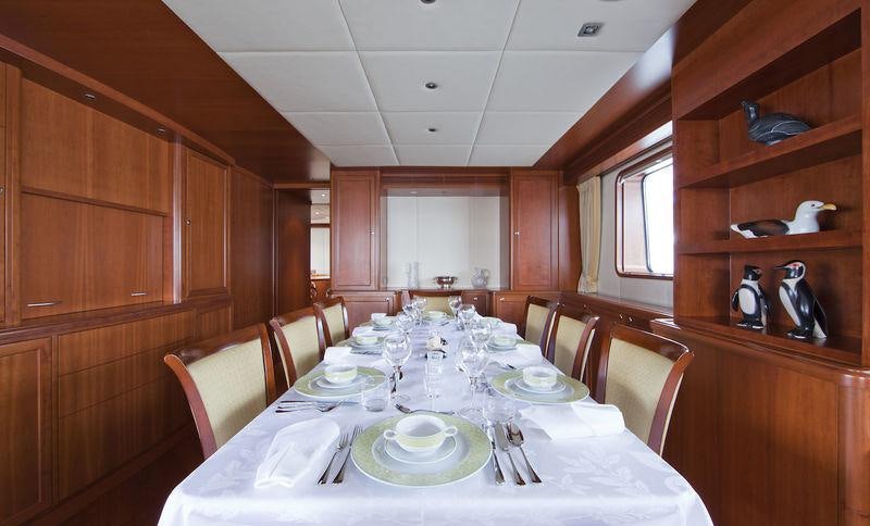a dining table set for a dinner aboard CORNELIA Yacht for Charter