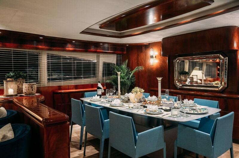 a dining room with a table and chairs aboard FOR YOUR EYES ONLY Yacht for Charter