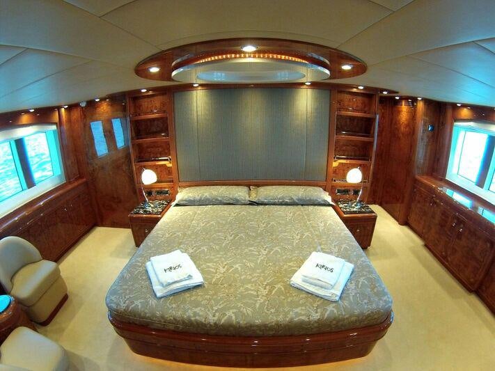 a bed with a book on it aboard KIRIOS Yacht for Charter