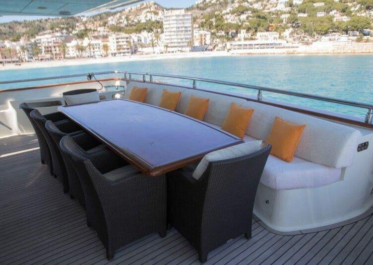 a table and chairs on a deck aboard KIRIOS Yacht for Charter