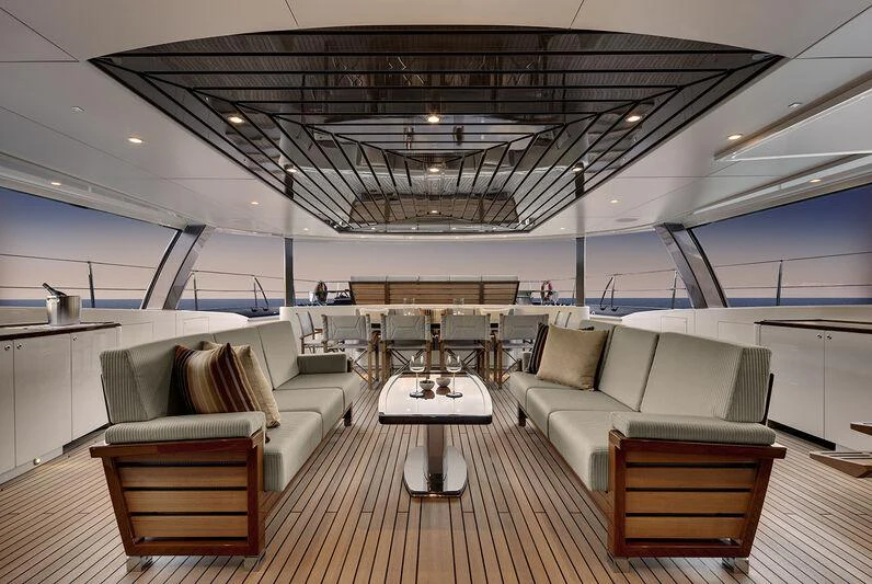 a large room with couches and tables aboard KOKOMO Yacht for Charter