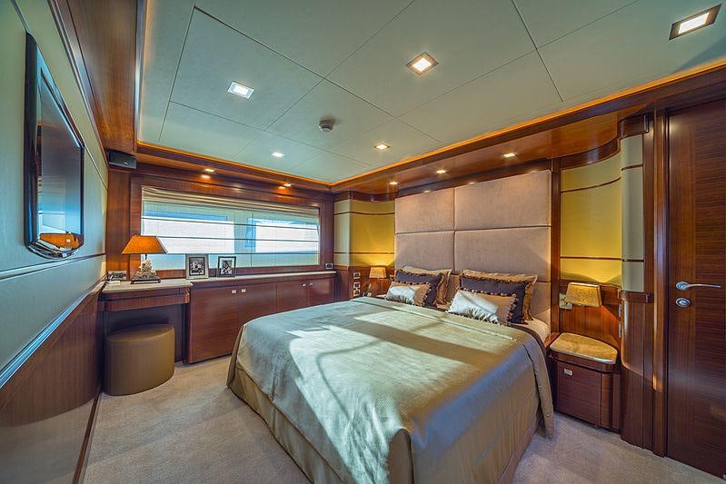 a bedroom with a bed and a desk aboard SEVENTH SENSE Yacht for Charter
