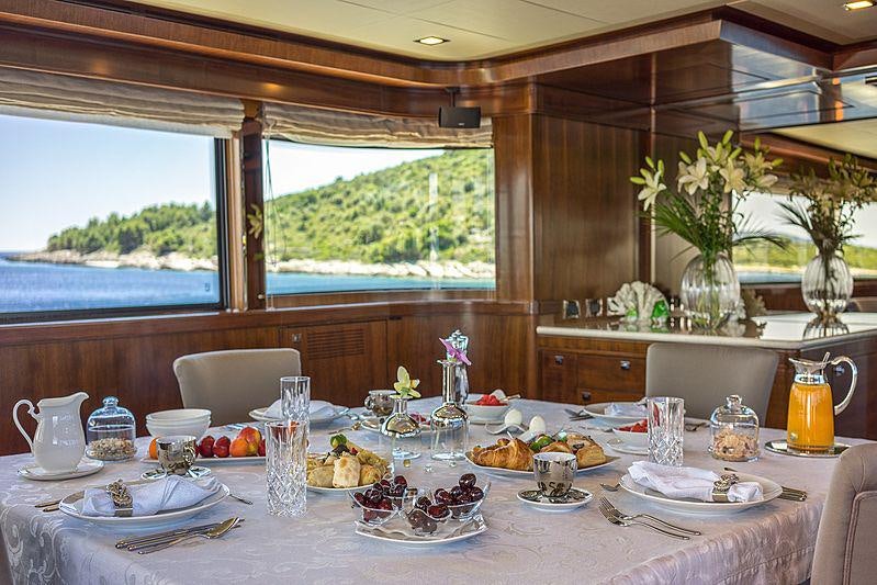 a table with plates and glasses aboard SEVENTH SENSE Yacht for Charter